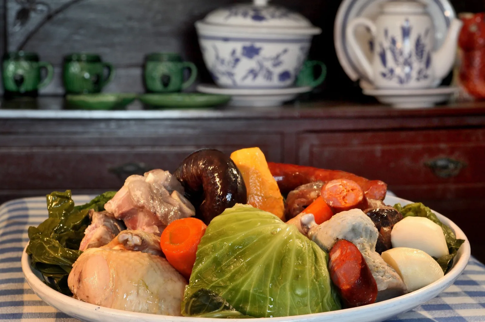 Cozido das Furnas served on a plate — São Miguel's iconic geothermal-cooked stew, Azores