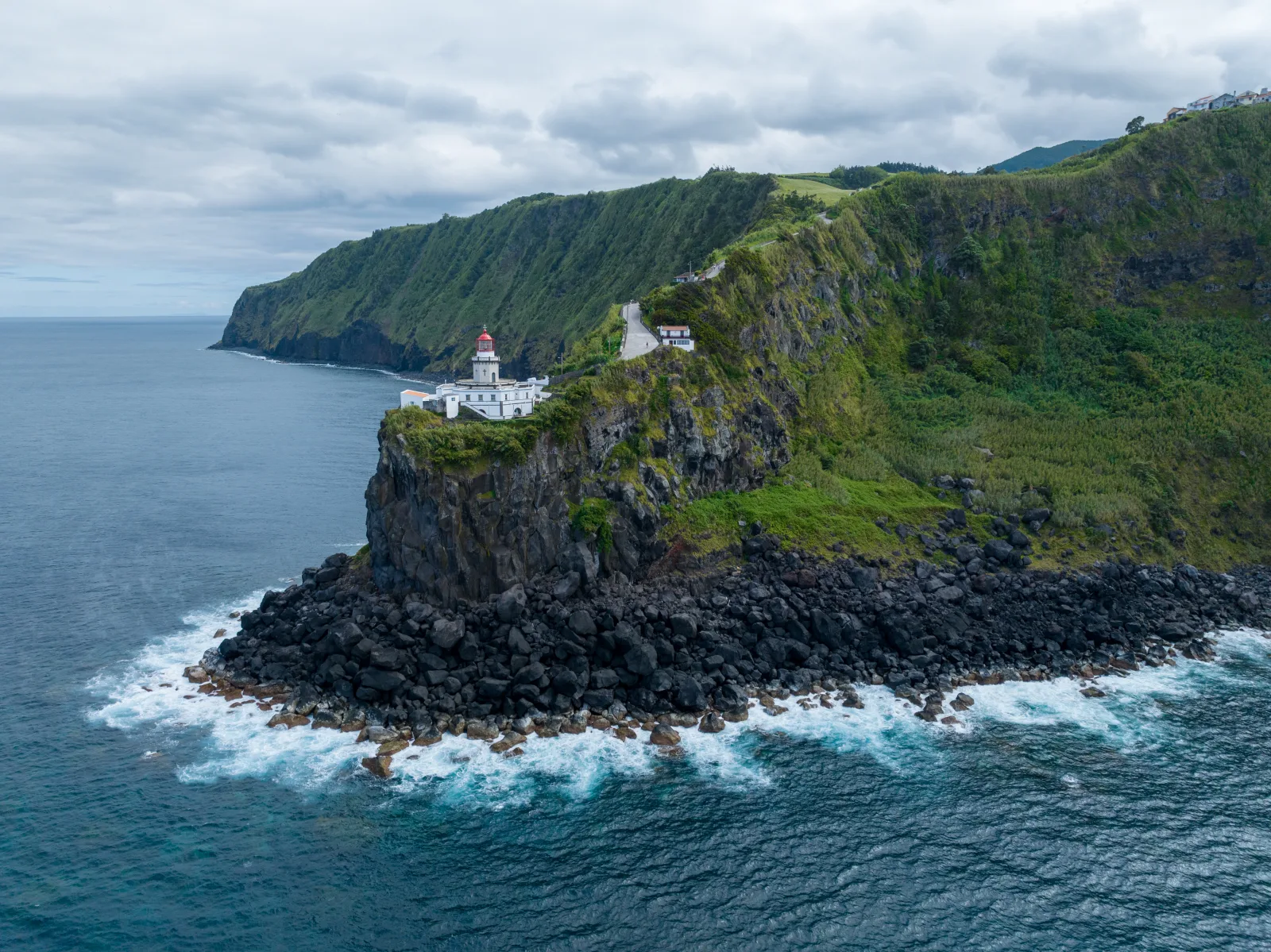 Farol do Arnel lighthouse on São Miguel's northeastern tip — the kind of remote spot you reach from the right base, Azores