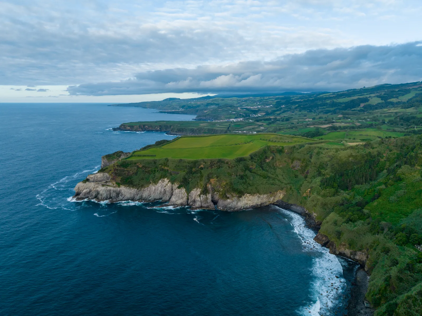 The rugged north coast of São Miguel from the Miradouro de Santa Iria — the dramatic Atlantic cliffs a short drive from the fishing town of Rabo de Peixe, Azores