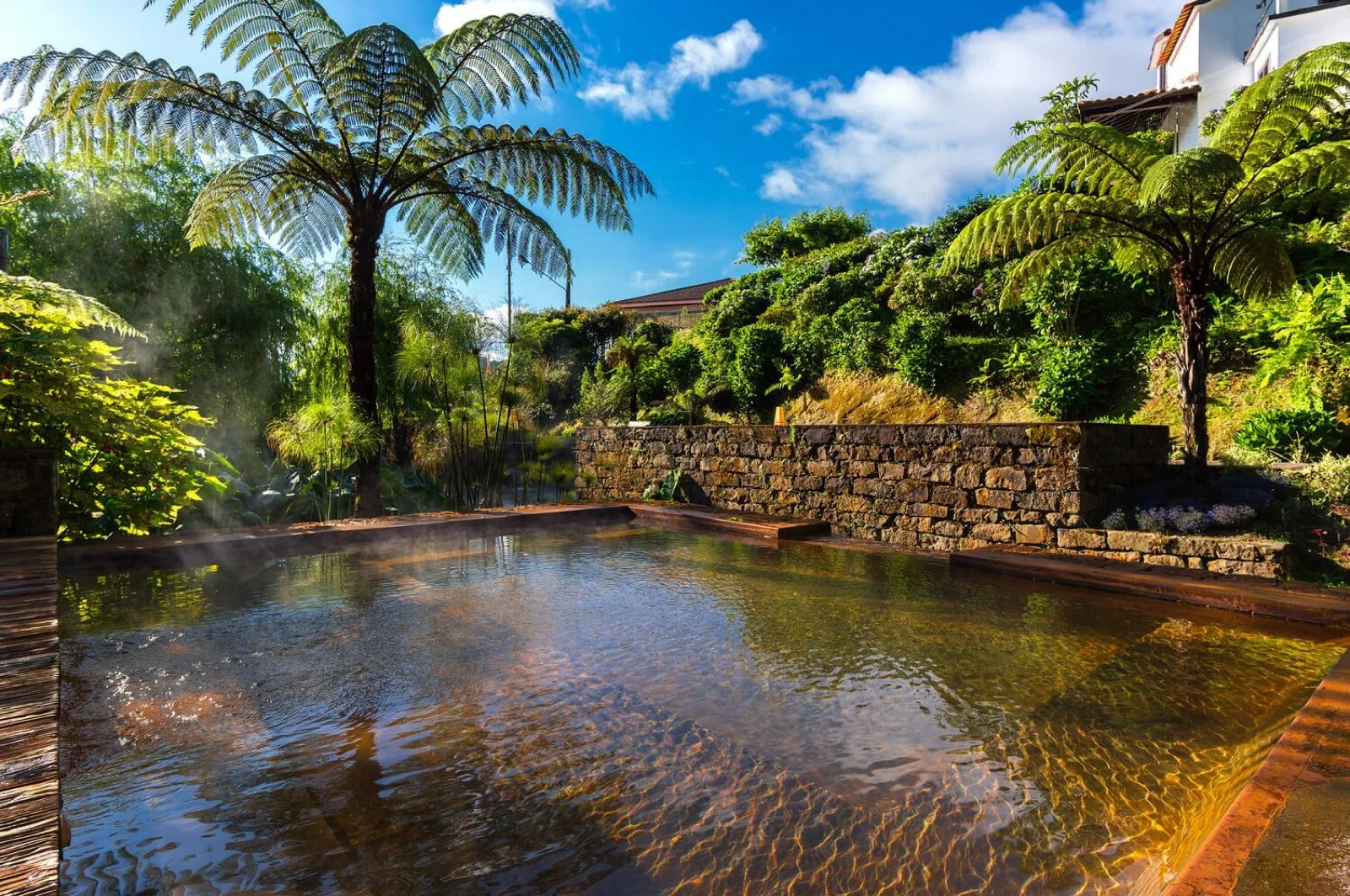 Poça da Dona Beija in Furnas, São Miguel — outdoor thermal rock pools with steam rising under low evening lighting