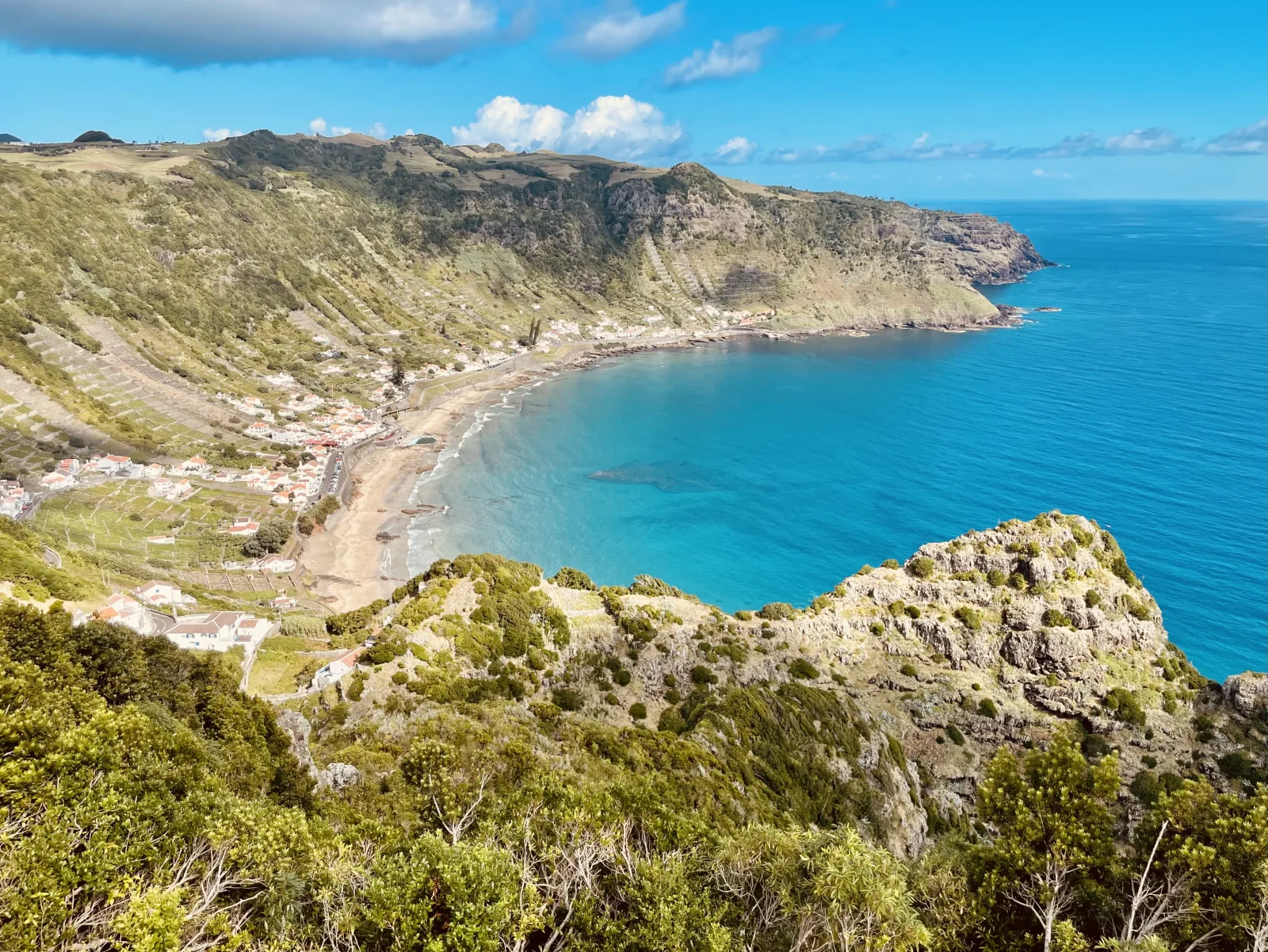 São Lourenço Bay on Santa Maria Island — turquoise water in the amphitheatre-shaped bay with terraced vineyards rising up the cliffs, Azores, Portugal