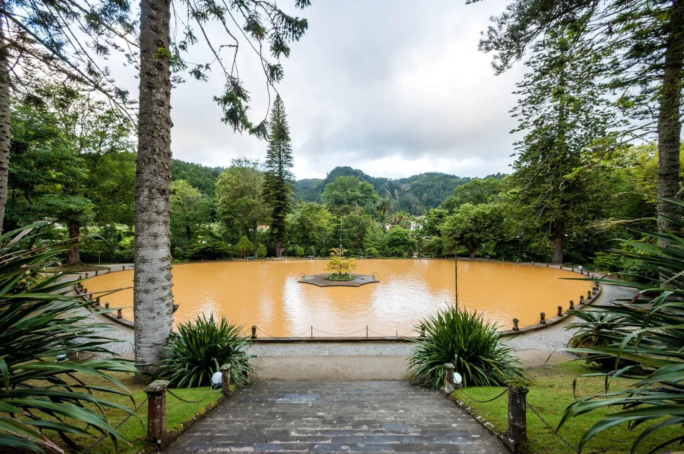 The iron-rich thermal pool at Parque Terra Nostra in Furnas — where the correct post-cozido afternoon is spent